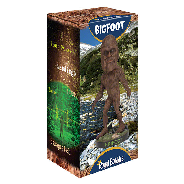 Box displaying a Bigfoot bobblehead against a mountainous landscape with a stream. Text includes "Bigfoot," "Orang Pendek," "Yowie," and "Sasquatch."