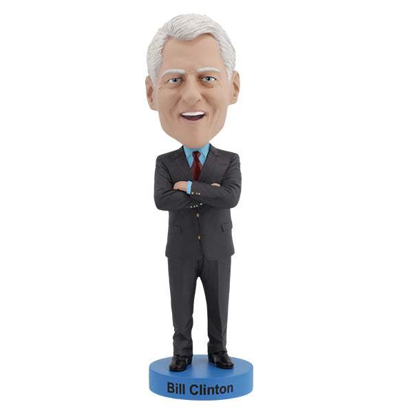 Features Bill Clinton bobblehead with gray hair, red tie, standing on a blue base labeled "Bill Clinton," arms crossed, smiling.