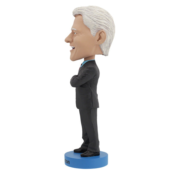 Left side view features Bill Clinton bobblehead with gray hair, red tie, standing on a blue base labeled "Bill Clinton," arms crossed, smiling.