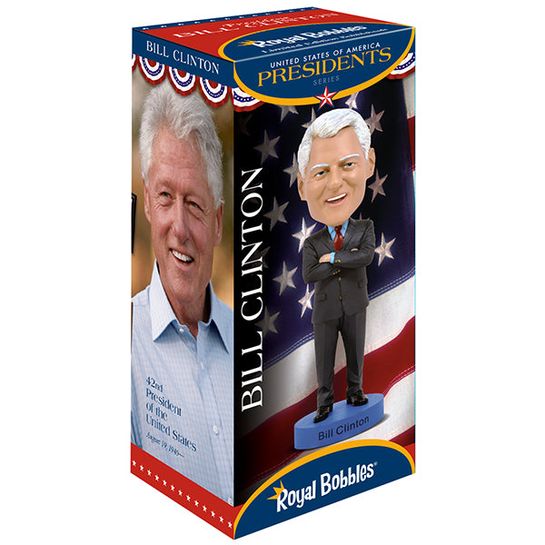 Box displaying a Bill Clinton bobblehead with arms crossed, set against an American flag background. The package features his photo and presidency info.