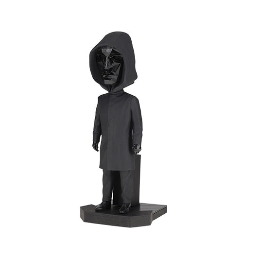 3/4 left view of black hooded figurine with geometric mask on pedestal.