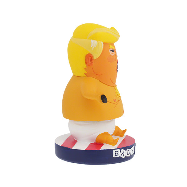Right side view of Baby Trump Bobblehips Caricature figurine of a baby with a yellow hairpiece, angry expression, wearing a diaper, and holding a phone. Base labeled "Baby Trump."