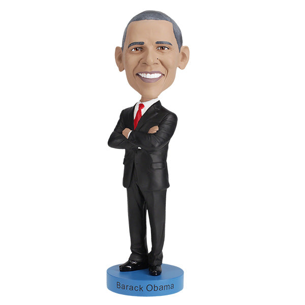Barack Obama bobblehead figurine dressed in a black suit and red tie, standing on a blue base labeled "Barack Obama".