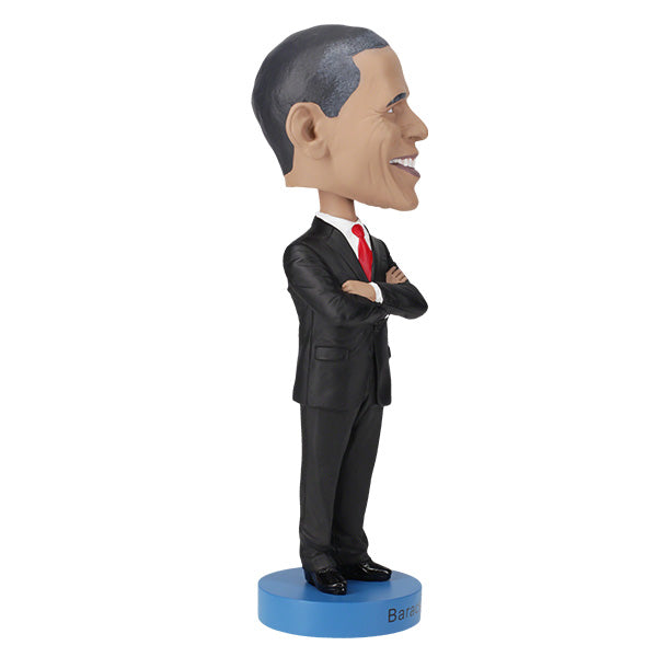 Right side view of Barack Obama bobblehead figurine dressed in a black suit and red tie, standing on a blue base labeled "Barack Obama".