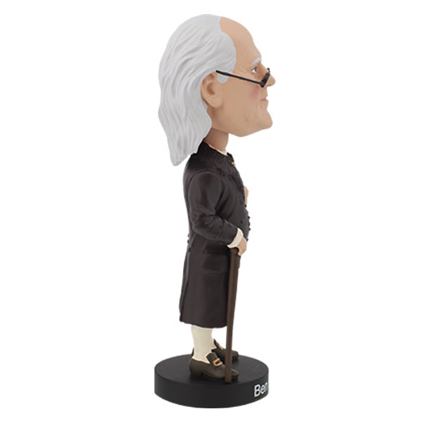 Right side view of Benjamin Franklin bobblehead featuring an elderly man with a bald head and long white hair, wearing glasses and colonial attire, stands on a base labeled "Ben Franklin."