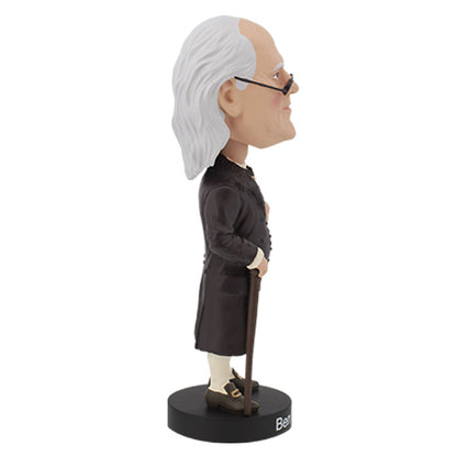 Right side view of Benjamin Franklin bobblehead featuring an elderly man with a bald head and long white hair, wearing glasses and colonial attire, stands on a base labeled "Ben Franklin."