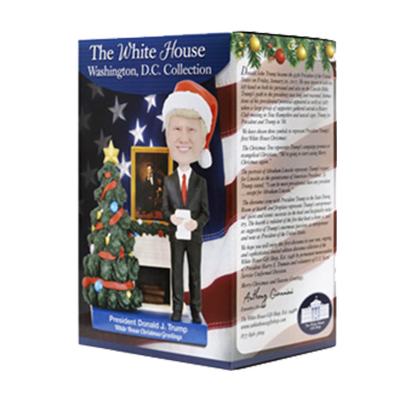 Bobblehead figure of a president in a Christmas hat, box