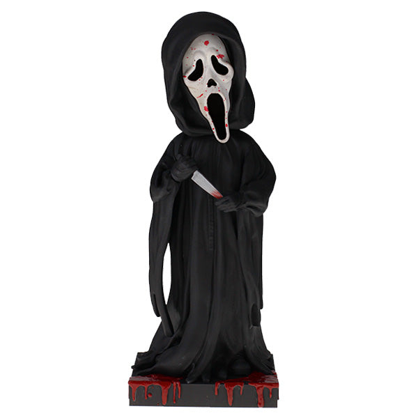 Statue of a character in a black hooded outfit with a mask and knife on a white background
