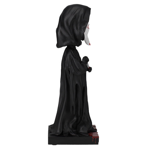 Statue of a character in a black hooded robe on a white background