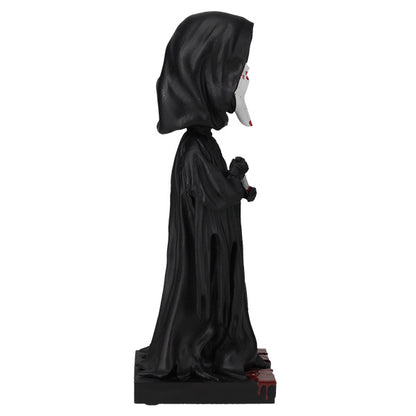 Statue of a character in a black hooded robe on a white background