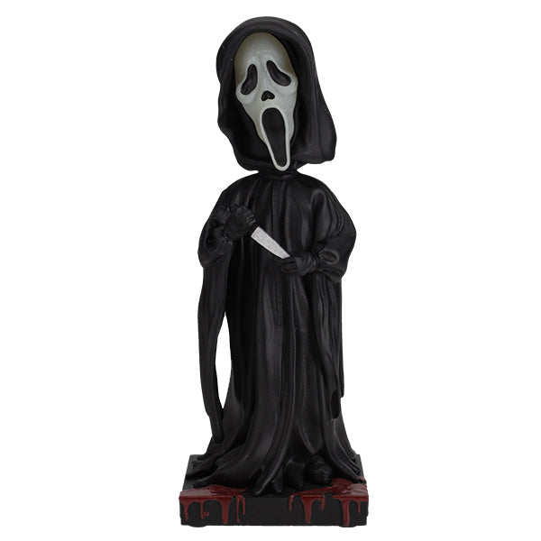 Statue of a character in a black hooded cloak with a white face mask on a white background