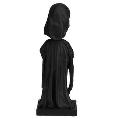 Black statue of a hooded figure on a white background