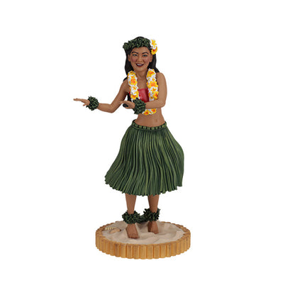 Hula dancer figurine in green grass skirt with floral lei on sandy base