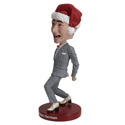 3/4 left view of Pee-wee Herman bobblehead in gray suit and Santa hat on red base.
