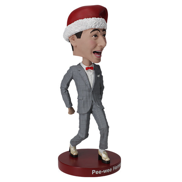 3/4 right view Pee-wee Herman bobblehead in gray suit and Santa hat on red base.