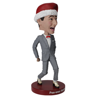 3/4 right view Pee-wee Herman bobblehead in gray suit and Santa hat on red base.
