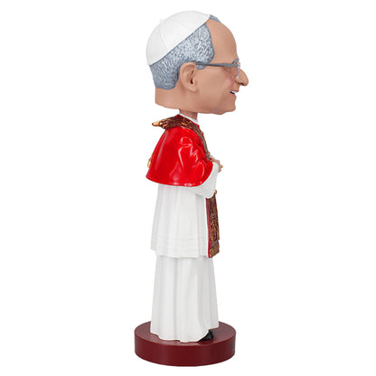 Right side view of a bobblehead of a smiling figure in papal attire with a red cape and ornate gold stole, posed against a plain background, labeled "Pope Leo XIV."