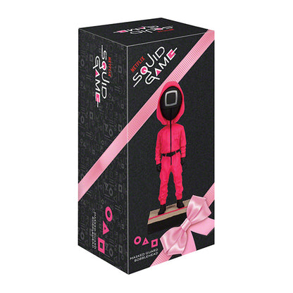 Squid Game masked guard bobblehead box with red-jumpsuit figure on black background.